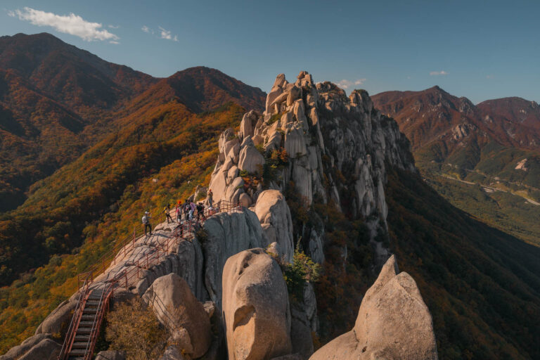 a group of people on a bridge over a mountain